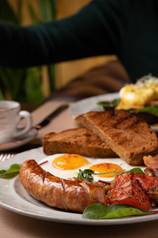 Full English breakfast - fried egg, baked beans, bacon, sausages